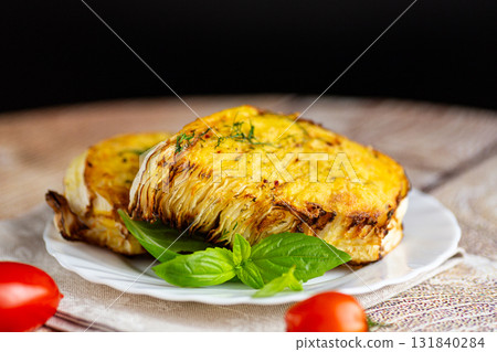 Baked cabbage wedges in crispy golden batter with herbs Baked cabbage wedges in crispy golden batter with herbs 131840284