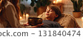 A calm atmosphere is created as a woman practices sound therapy with a child lying down. Natural elements and soft lighting enhance the tranquil experience of the session, banner 131840474