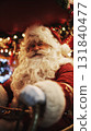 A cheerful Santa Claus with a thick white beard and red suit sits comfortably, holding a steering wheel amidst twinkling holiday lights and vibrant decorations, spreading festive cheer 131840477