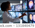 A doctor wearing a white coat and glasses intently studies various diagnostic images displayed on a digital screen in a hospitals dimly lit diagnostics room 131840479