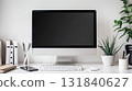 Computer desktop with plant and stationery on white table. 131840627