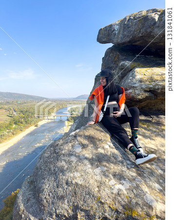 Person Enjoying Scenic View from Rocky Cliff Person Enjoying Scenic View from Rocky Cliff 131841061
