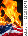 American flag burning in fire representing national crisis 131841076