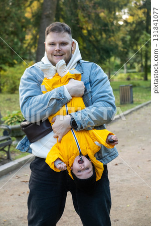 Playful Moment: Man and Baby in the Park 131841077