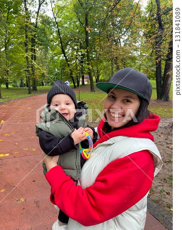 Mother and Baby Enjoying Autumn in the Park Mother and Baby Enjoying Autumn in the Park 131841089