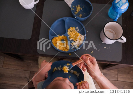 Baby Eating Rice and Eggs with Spoon Baby Eating Rice and Eggs with Spoon 131841136
