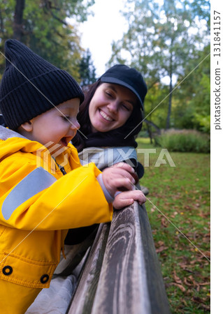 Child and Woman Enjoying a Park Bench Child and Woman Enjoying a Park Bench 131841157