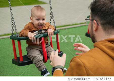 Father and Baby Enjoying Swing Time Father and Baby Enjoying Swing Time 131841166