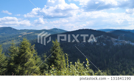 Lush green valley and mountains dominating the landscape under blue sky 131841190