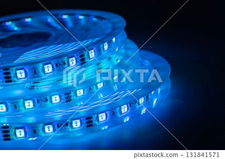 Blue LED strip light roll glowing in the dark modern lighting technology concept 131841571