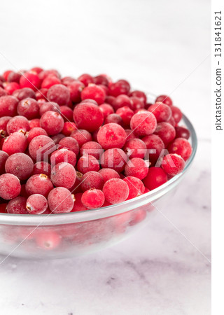 bowl of frozen cranberries on light background. Preservation of vegetables and fruits. Natural products 131841621
