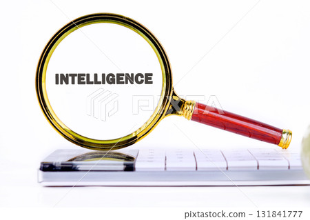 INTELLIGENCE text showed through the magnifying glass on the calculator. Futuristic Concept of Intelligence, science and mind 131841777