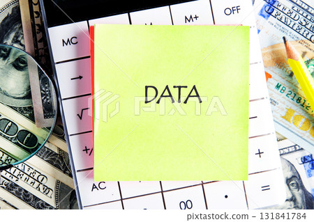 DATA word written on the sticker on the calculator on the background of banknotes. Business strategy success concept DATA word written on the sticker on the calculator on the background of banknotes. Business strategy success concept 131841784