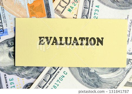 EVALUATION text written on yellow paper on the background of banknotes. Customer Satisfaction Survey Concept EVALUATION text written on yellow paper on the background of banknotes. Customer Satisfaction Survey Concept 131841787