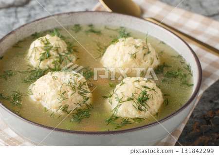 Jewish matzah balls soup with chicken broth, vegetables and dill close-up in a plate. Horizontal Jewish matzah balls soup with chicken broth, vegetables and dill close-up in a plate. Horizontal 131842299