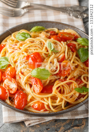 Margherita Spaghetti made with tomatoes, basil, and mozzarella closeup on the plate. Vertical Margherita Spaghetti made with tomatoes, basil, and mozzarella closeup on the plate. Vertical 131842312