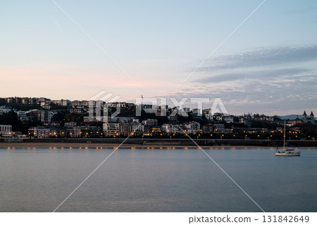 Resort hotels lined up along Concha Beach in San Sebastian and the street lights in the morning glow 131842649