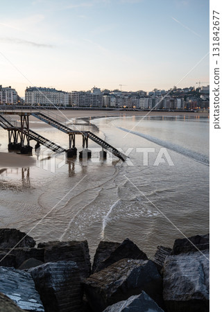 Resort hotels lined up along Concha Beach in San Sebastian and the street lights in the morning glow 131842677