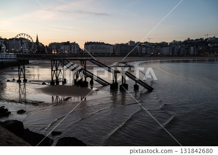 Resort hotels lined up along Concha Beach in San Sebastian and the street lights in the morning glow Resort hotels lined up along Concha Beach in San Sebastian and the street lights in the morning glow 131842680