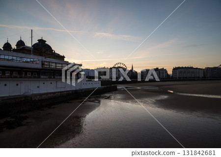 Resort hotels lined up along Concha Beach in San Sebastian and the street lights in the morning glow Resort hotels lined up along Concha Beach in San Sebastian and the street lights in the morning glow 131842681
