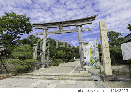 The torii gate and worship hall of Keta Taisha Shrine in Ishikawa Prefecture, a historic shrine standing under a blue sky The torii gate and worship hall of Keta Taisha Shrine in Ishikawa Prefecture, a historic shrine standing under a blue sky 131842935