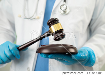 Doctor holding judge gavel, medical law and crime justice. 131843405