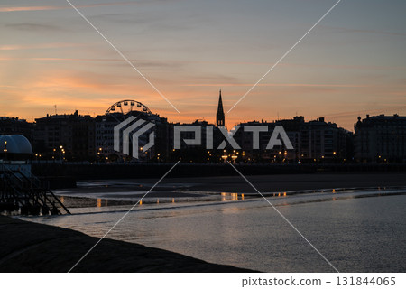 Resort hotels lined up along Concha Beach in San Sebastian and the street lights in the morning glow Resort hotels lined up along Concha Beach in San Sebastian and the street lights in the morning glow 131844065