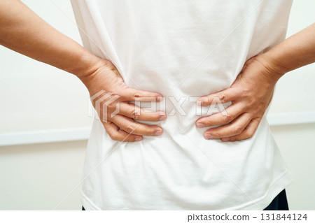 Asian man pain back muscle, spine and bone from accident. 131844124