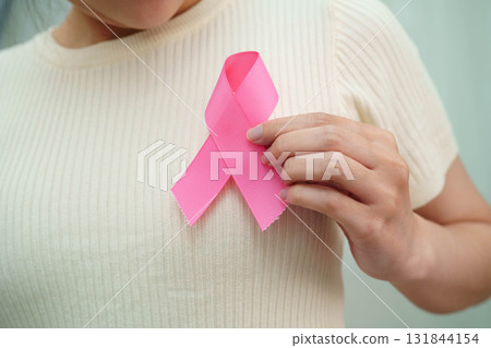 Asian woman with pink ribbon for October world breast cancer day. Asian woman with pink ribbon for October world breast cancer day. 131844154
