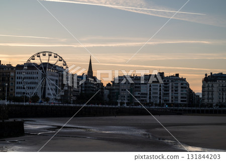 Resort hotels lined up along Concha Beach in San Sebastian and the street lights in the morning glow Resort hotels lined up along Concha Beach in San Sebastian and the street lights in the morning glow 131844203
