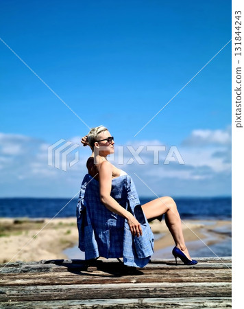 Woman Posing Bare-Shouldered With Jacket On Log Woman Posing Bare-Shouldered With Jacket On Log 131844243