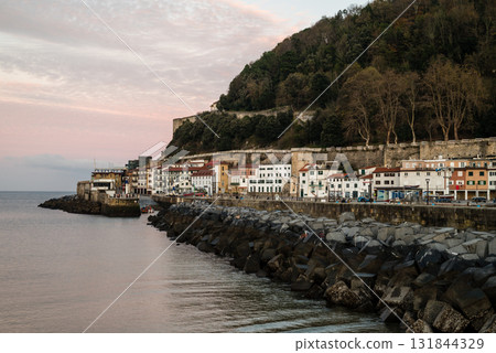 Resort hotels lined up along Concha Bay in San Sebastian and the street lights in the morning glow Resort hotels lined up along Concha Bay in San Sebastian and the street lights in the morning glow 131844329