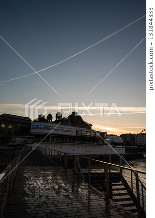 Resort hotels lined up along Concha Beach in San Sebastian and the street lights in the morning glow Resort hotels lined up along Concha Beach in San Sebastian and the street lights in the morning glow 131844333