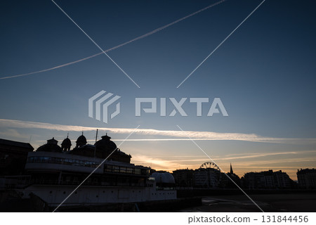 Resort hotels lined up along Concha Beach in San Sebastian and the street lights in the morning glow Resort hotels lined up along Concha Beach in San Sebastian and the street lights in the morning glow 131844456