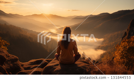 woman meditating on the mountains on the sunrise 131844553