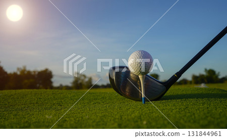 Golf clubs and balls on a green lawn in a beautiful golf course with morning sunshine. 131844961
