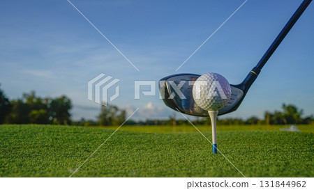 Golf clubs and balls on a green lawn in a beautiful golf course with morning sunshine. 131844962
