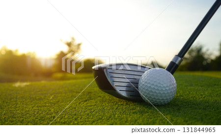 Golf clubs and balls on a green lawn in a beautiful golf course with morning sunshine. 131844965