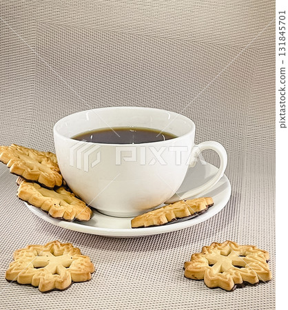 A cozy coffee break with black coffee and golden, patterned butter cookies on a textured surface A cozy coffee break with black coffee and golden, patterned butter cookies on a textured surface 131845701