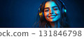 A cheerful girl with headphones, grinning against a dark blue backdrop, showcasing the connection between music and emotion in a clean and minimalist portrait style, banner 131846798