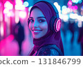 A futuristic high-tech portrait of a smiling Arabian girl wearing headphones, illuminated by a vibrant neon background, exuding confidence, energy, passion for music or studies 131846799