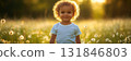 Adorable young model in a white t-shirt and jeans trousers stands happily against a vivid spring green background, creating a playful and fresh visual appeal, banner 131846803