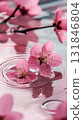 The surface of muted pink water is adorned with floating pink flowers, their petals gently creating ripples in the calm, tranquil water 131846804
