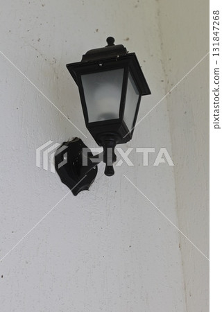 Vintage black lantern on a white wall 131847268