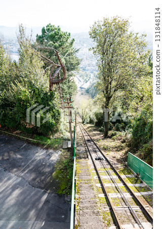 A straight cable car track and the cityscape seen in the distance from the top of Monte Igueldo in San Sebastian 131848114