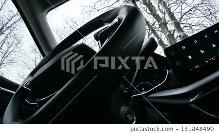 Bottom view of the steering wheel and touch screen monitor with icons of applications in the car 131848490