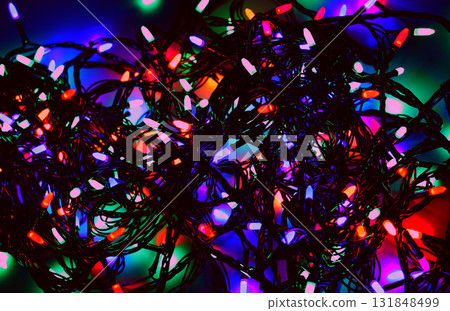 Long festive garland with multi colored lights glowing in the dark Long festive garland with multi colored lights glowing in the dark 131848499