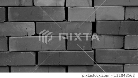 Cracks run through stacked bricks black and white photo for backgrounds. Traditional construction materials stock image Cracks run through stacked bricks black and white photo for backgrounds. Traditional construction materials stock image 131848568