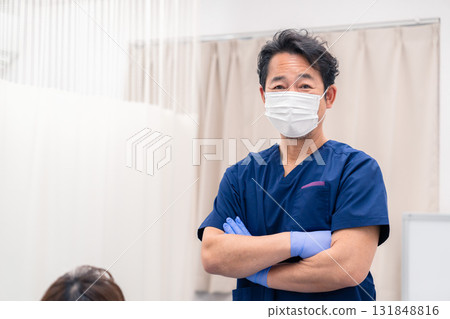 Middle-aged male doctor at dental clinic Middle-aged male doctor at dental clinic 131848816