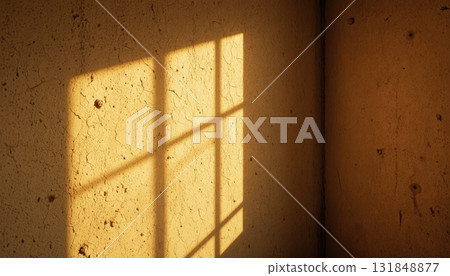 Golden Sunlight Creates a Warm Pattern on a Rustic Wall in a Quiet Room 131848877